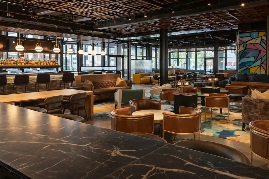 Empty modern upscale bar interior with diverse seating and a full bar.