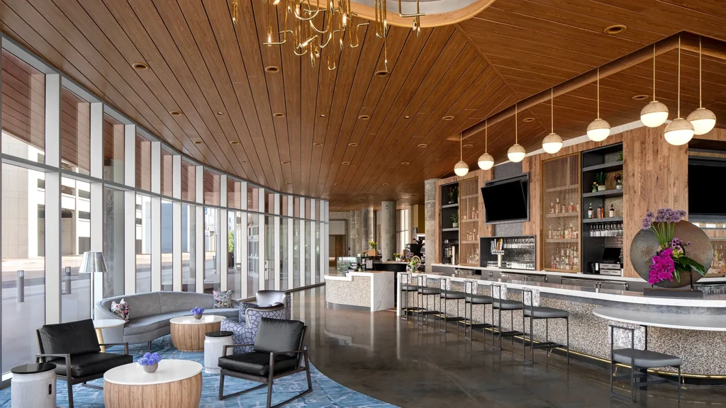 Empty modern lounge and bar with sofa, windows, and chandelier.