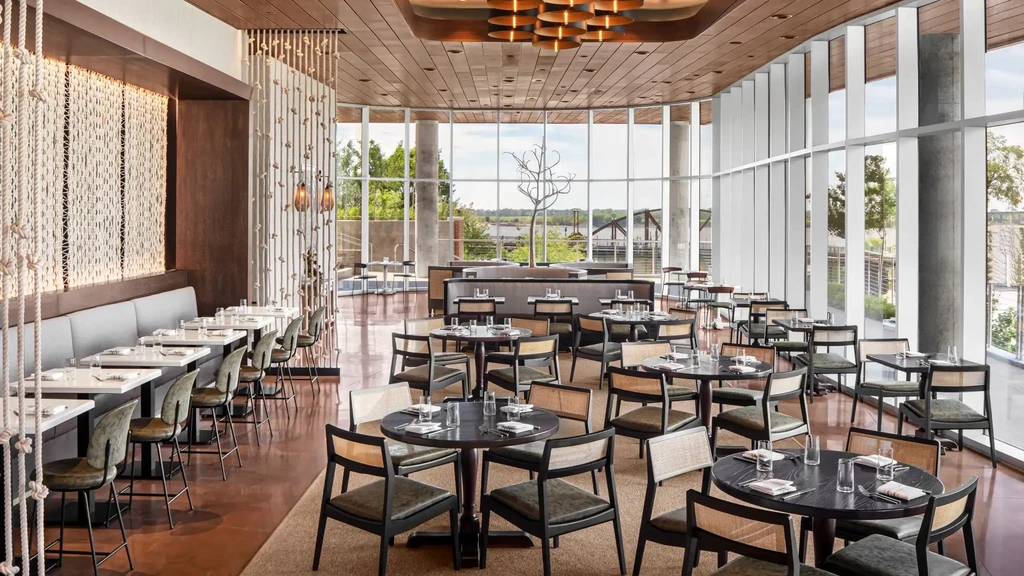 Empty, modern restaurant interior with elegant decor and natural light.