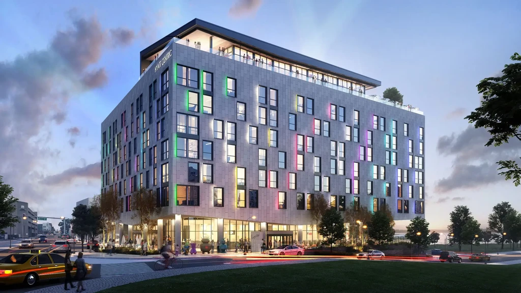 A modern Hyatt Centric hotel with colorful lights and a bustling city street.