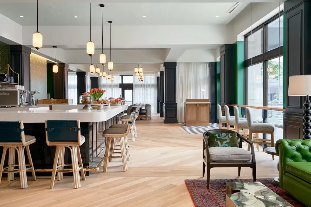 Spacious modern lounge with a curved bar and vibrant green sofa.