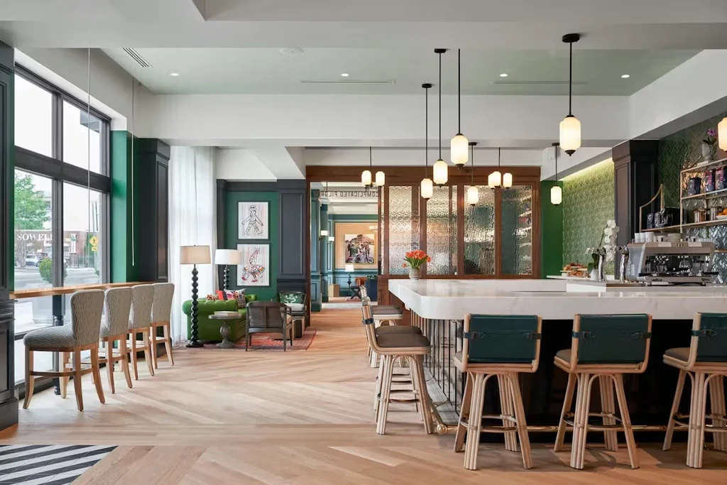 Stylish, empty modern restaurant interior with bar, lounge, and street view.