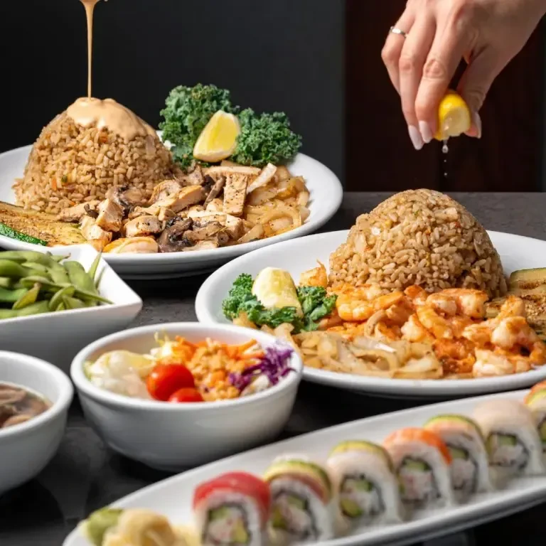 Japanese-inspired spread of fried rice, sushi, salad, and side dishes.