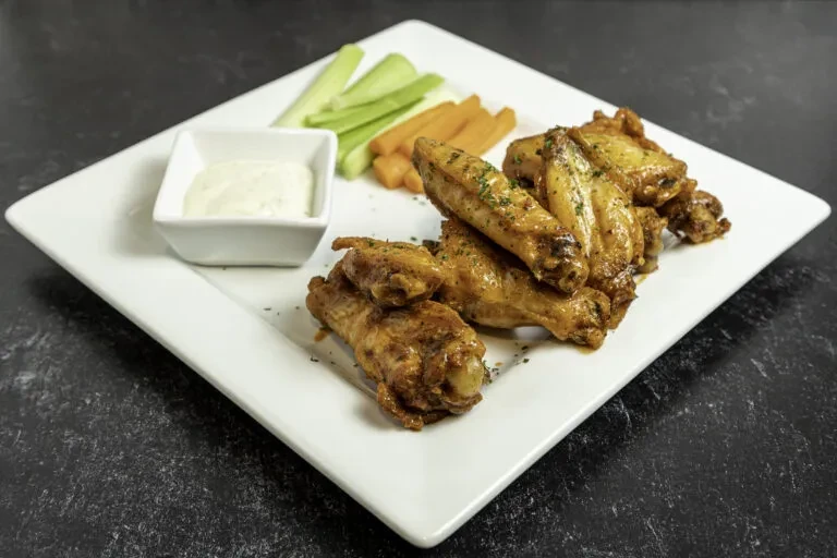 Glazed chicken wings, creamy dip, celery, and carrot sticks.