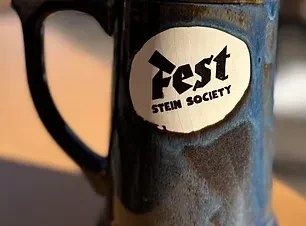 Rustic dark blue ceramic stein with "Fest STEIN SOCIETY" logo.