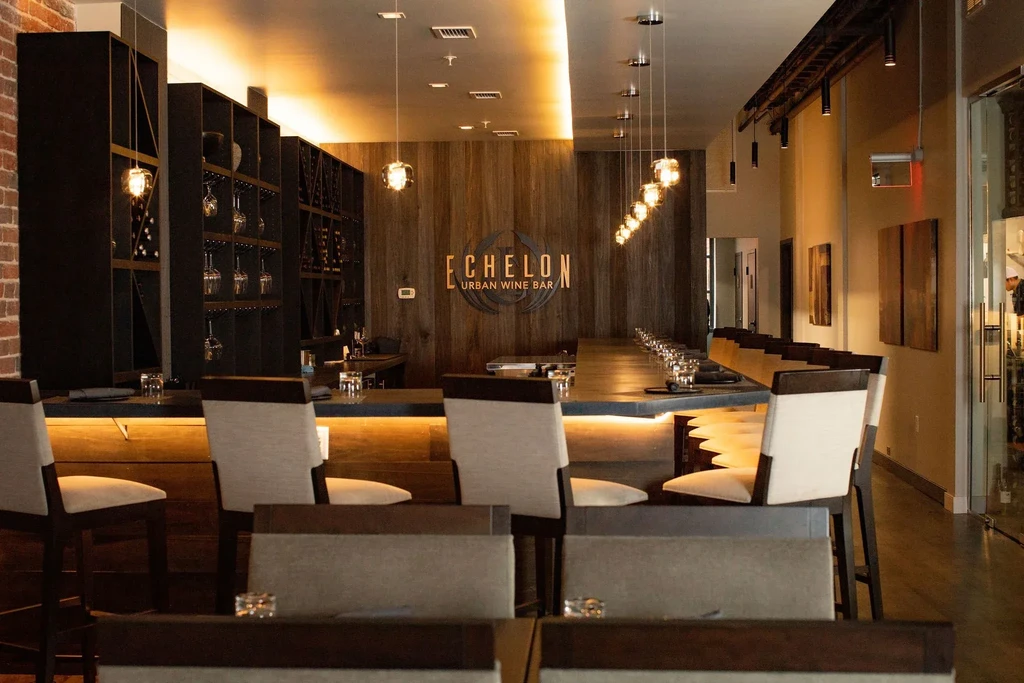 Echelon Urban Wine Bar interior with a long, illuminated bar counter.