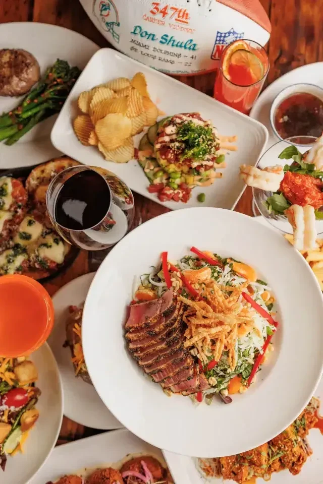 Abundant food and drinks surround a Don Shula Dolphins victory football.