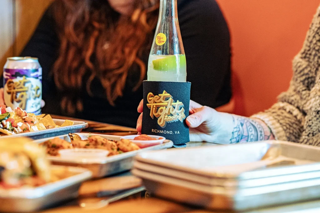 Nachos, fried food, and branded drinks on a lounge table.