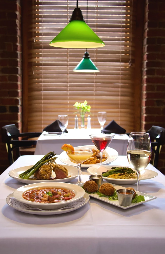Restaurant table with diverse, meticulously arranged dishes and drinks.