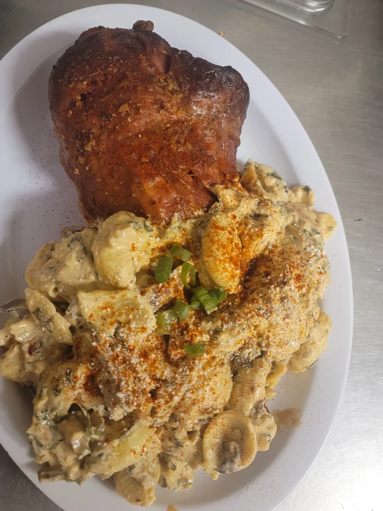 Roasted meat and creamy shell pasta topped with spices and chives.