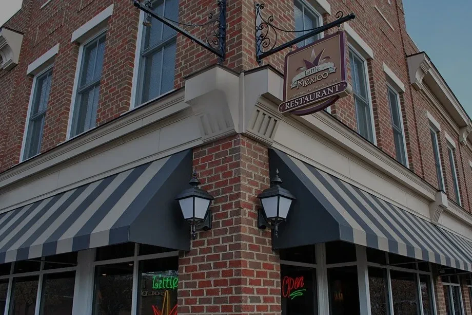 Little Mexico restaurant exterior, red brick, awnings, and prominent sign.