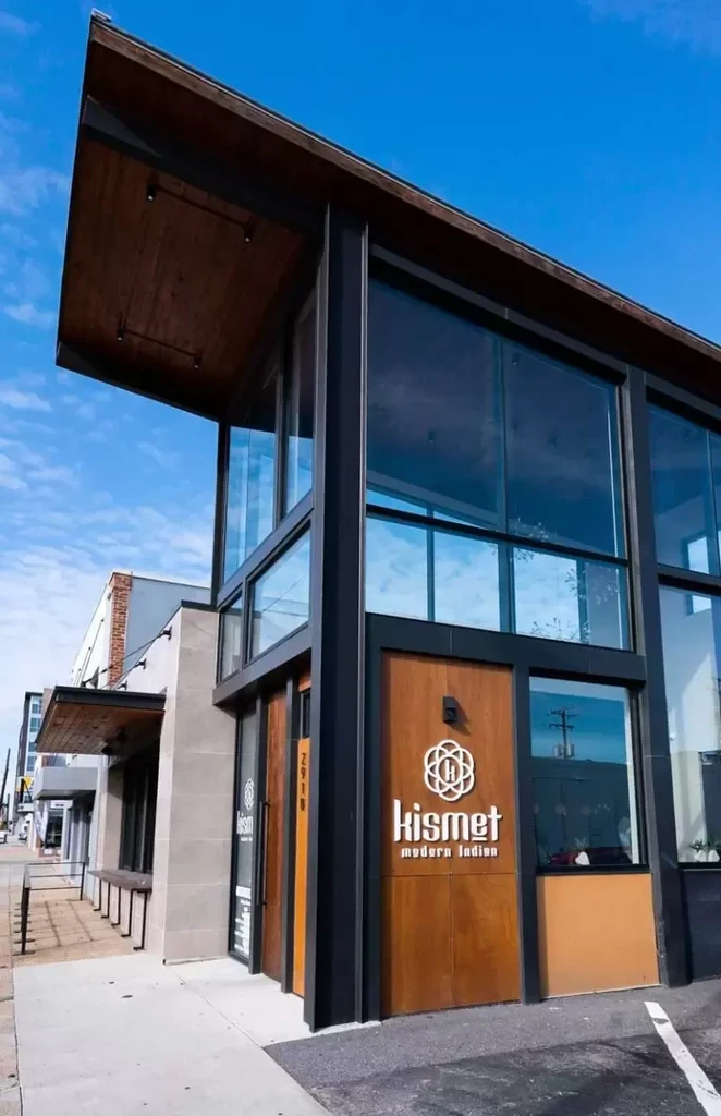 Exterior of kismet modern Indian restaurant, modern design, glass and wood.
