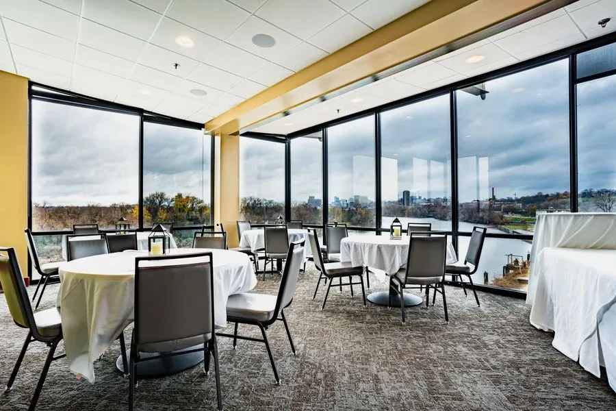 Spacious dining room with panoramic river and city views.