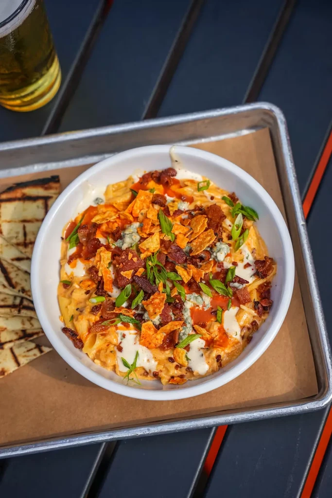 Creamy macaroni and cheese topped with bacon, blue cheese, and scallions.