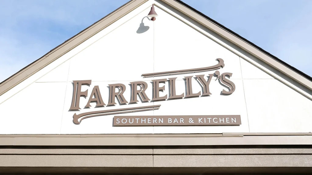 Cream gable of Farrelly's Southern Bar & Kitchen building with brown signs.