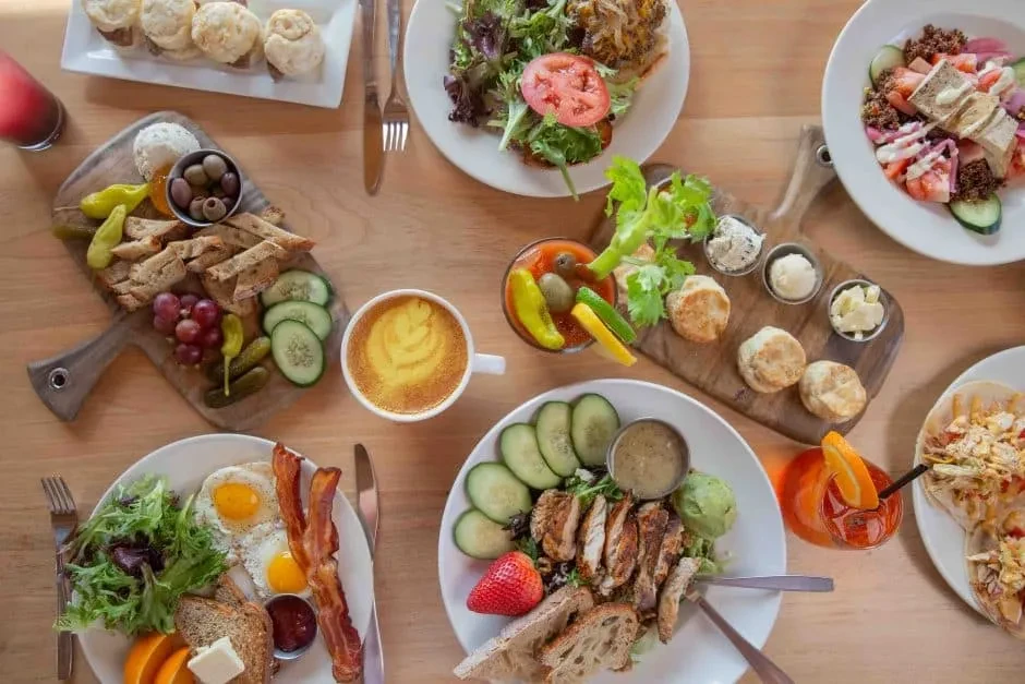 Overhead shot of a large breakfast, brunch, and drinks spread.