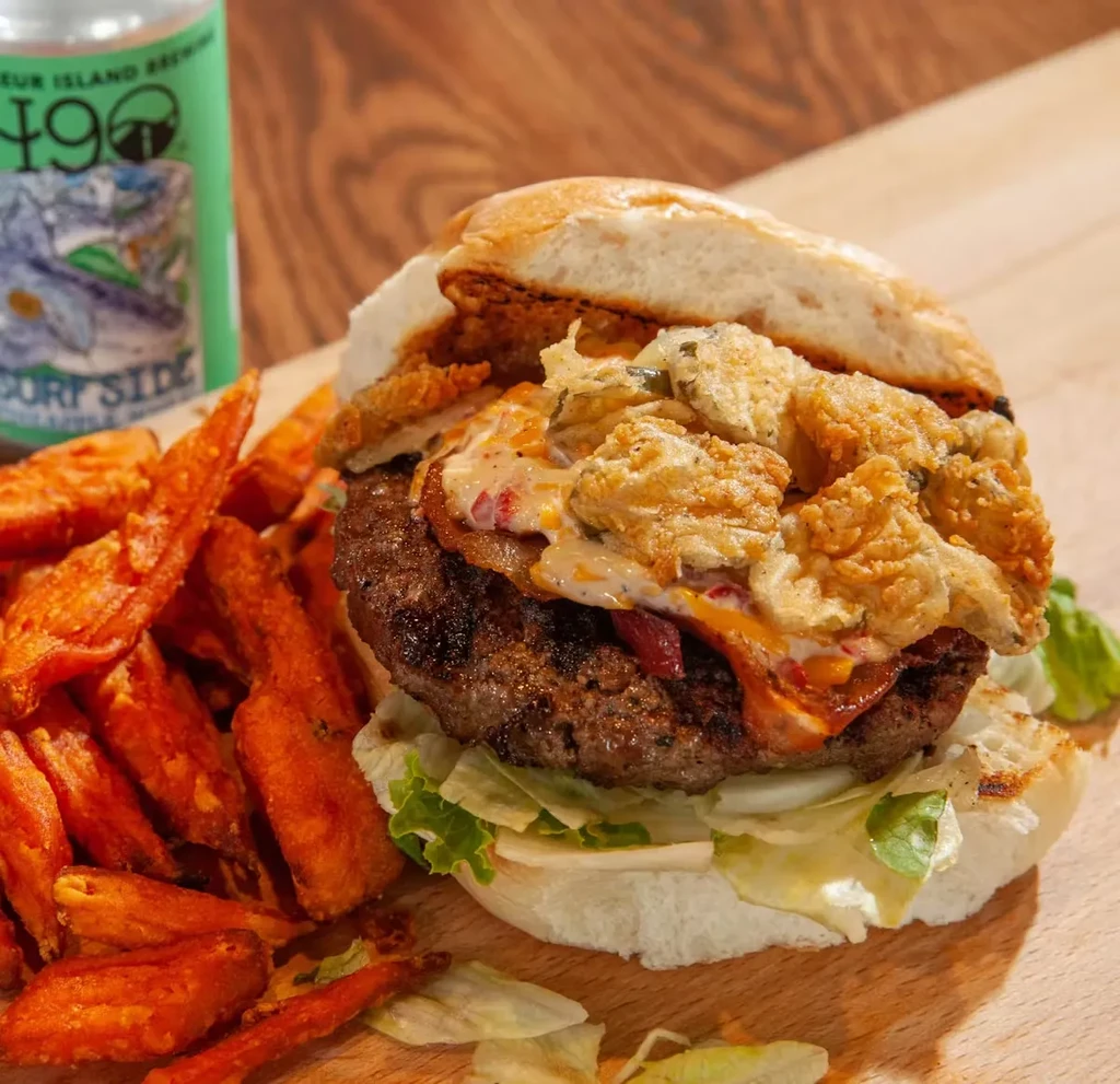 Gourmet burger, sweet potato fries, and "Fleur Island Brew" can.
