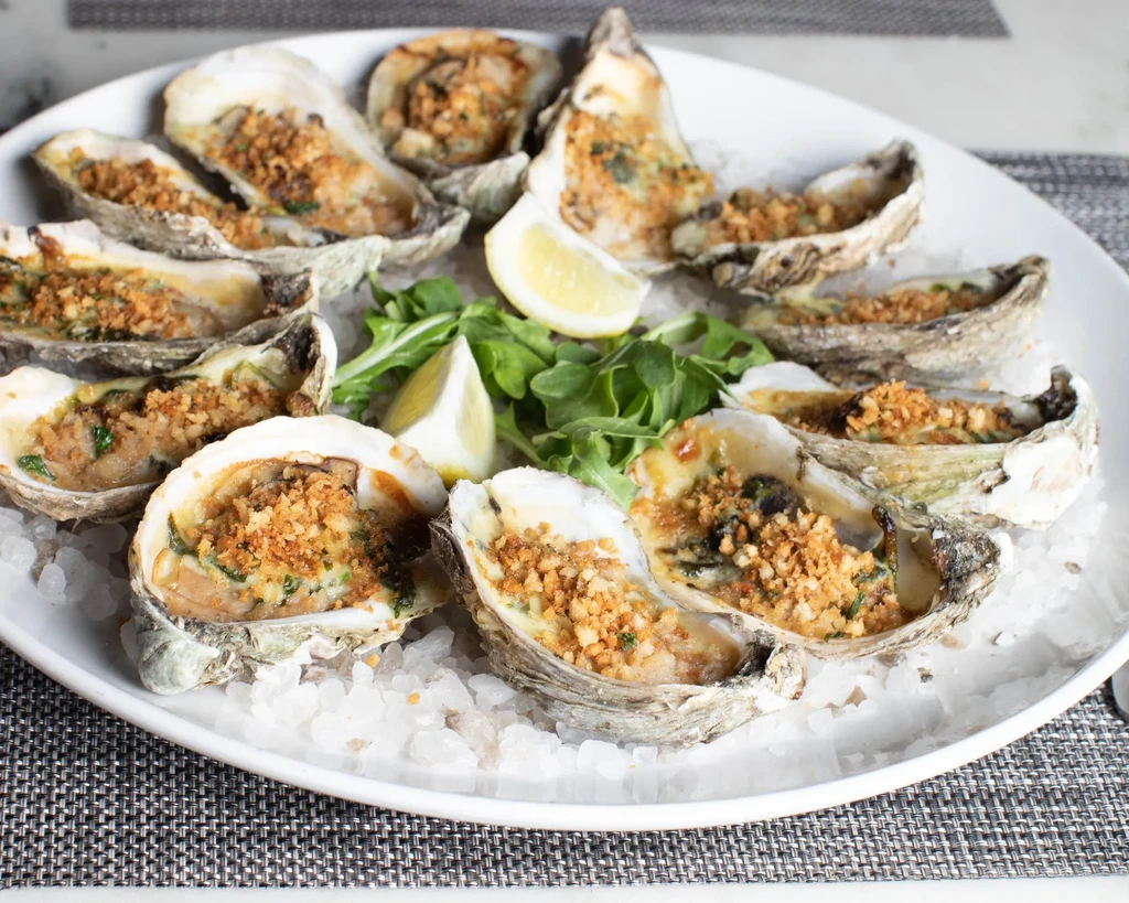 Baked oysters on half shell, breadcrumbs, lemon, served on crushed ice.