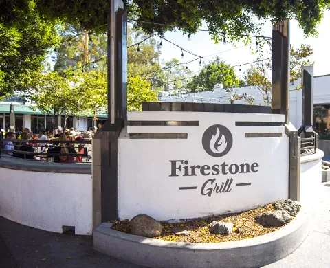 Firestone Grill restaurant's busy outdoor patio and string lights.