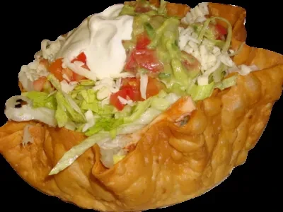 Close-up of a taco salad in a crispy fried tortilla bowl.