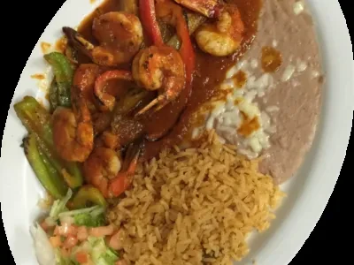 Full plate of shrimp, refried beans, Spanish rice, and salad.