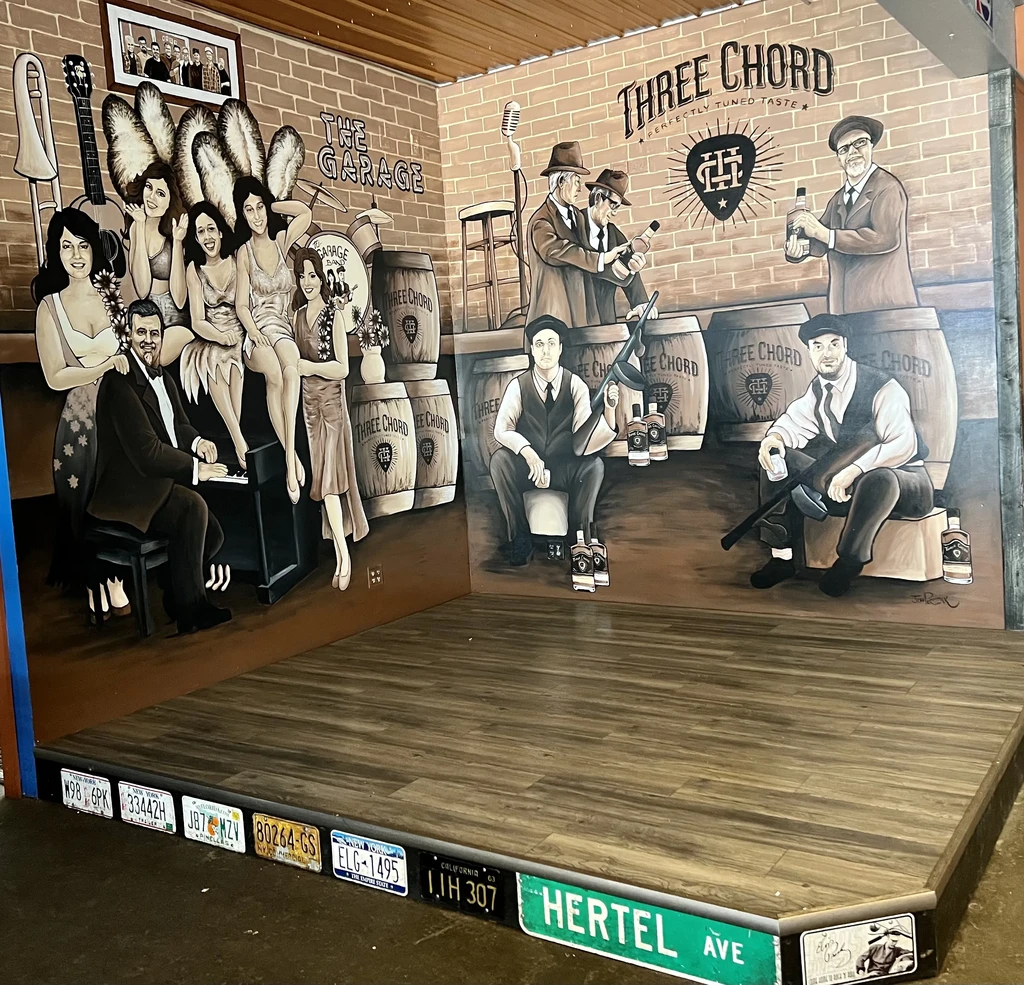 Vintage mural depicting jazz club and speakeasy scenes on corner walls.