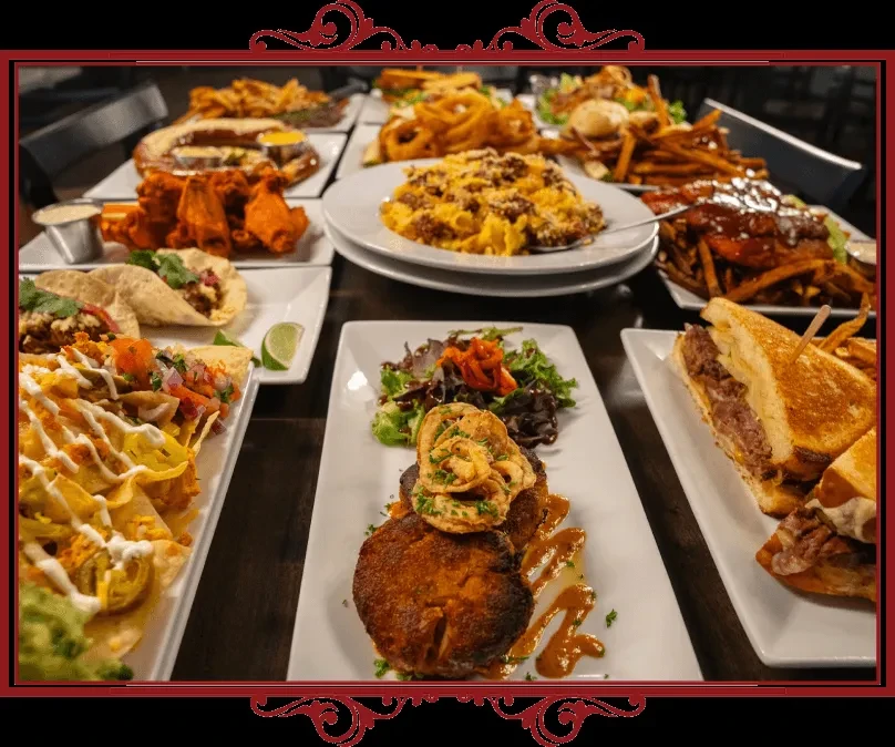 Abundant spread of restaurant appetizers and main courses on a table.