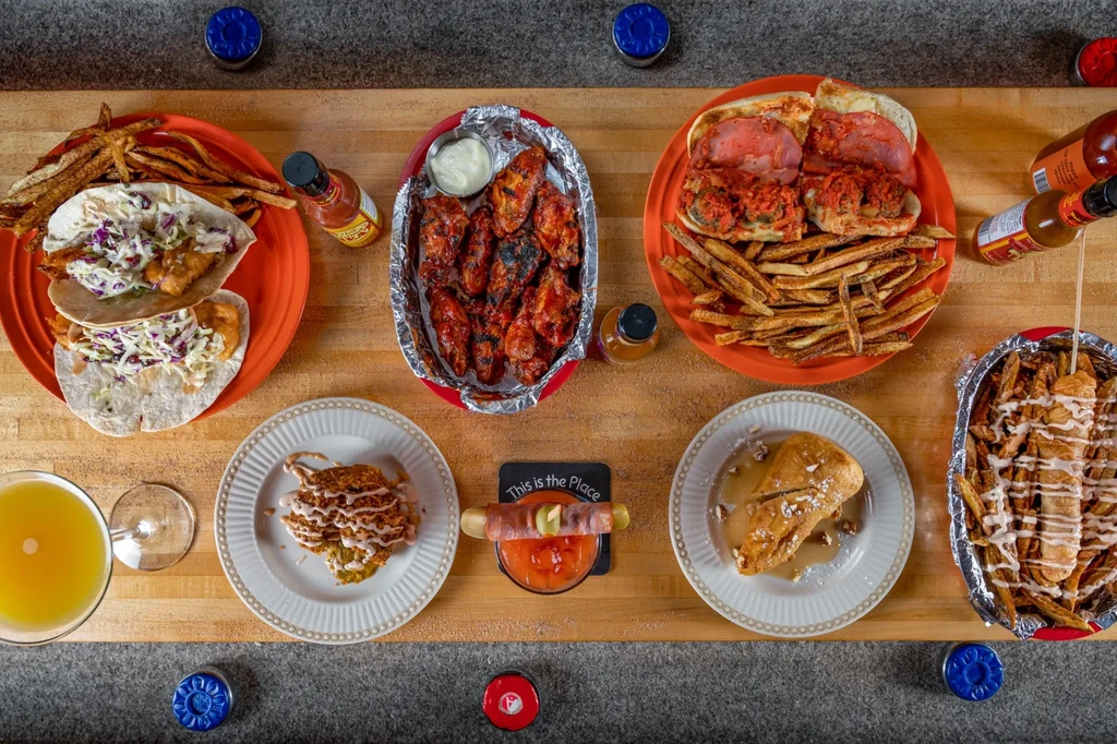Top-down view of various casual restaurant dishes and drinks.