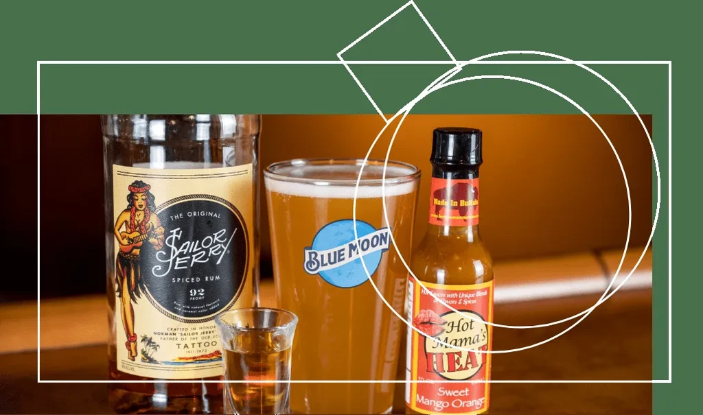 Sailor Jerry rum, shot glass, Blue Moon beer, and Hot Mama's hot sauce.
