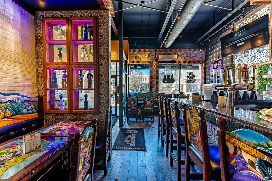 Colorful, elaborately decorated interior of a Mexican restaurant with bar.