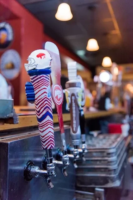 Beer tap handle with a Buffalo Bills helmet.