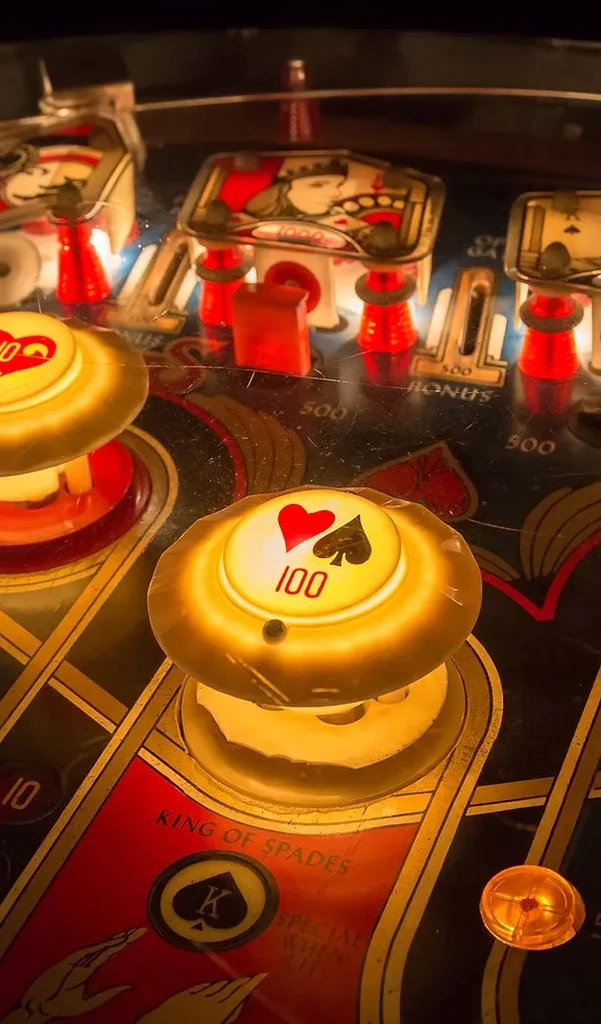 Glowing 100-point bumper on a vintage pinball machine playfield.
