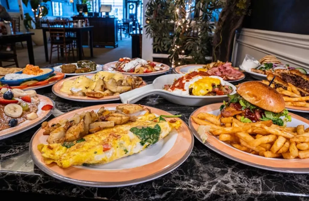 Vibrant spread of various breakfast and brunch dishes on a marble table.