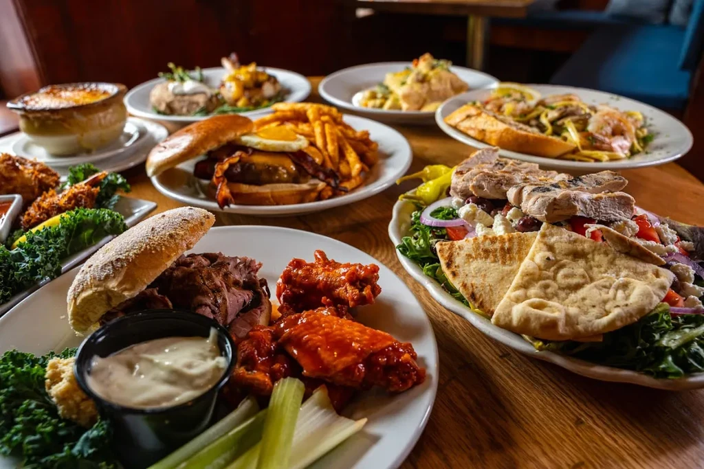 Restaurant table laden with a varied spread of hearty comfort food.