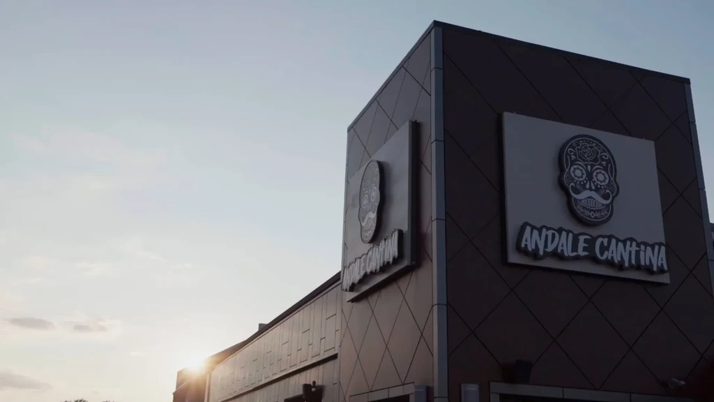Andale Cantina building with a geometric tiled facade and sugar skull sign.