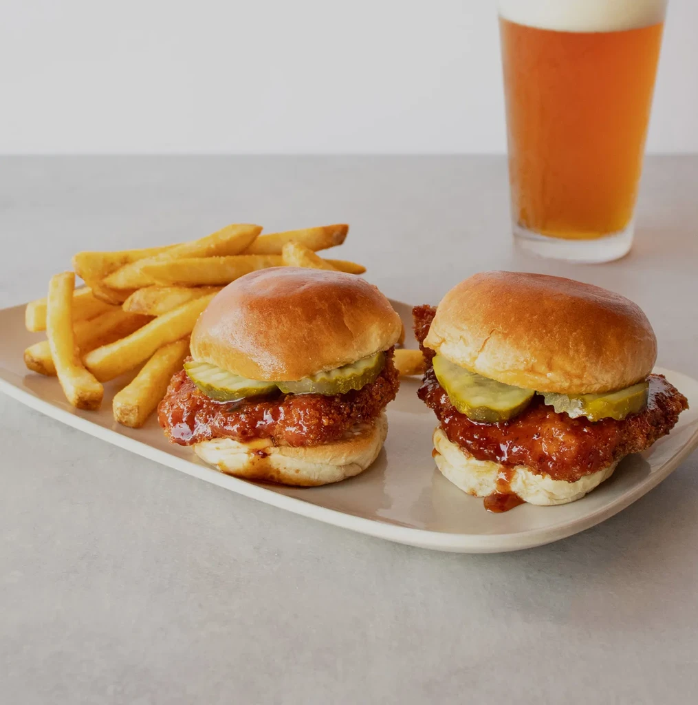 Two crispy sliders, golden fries, and a beer.