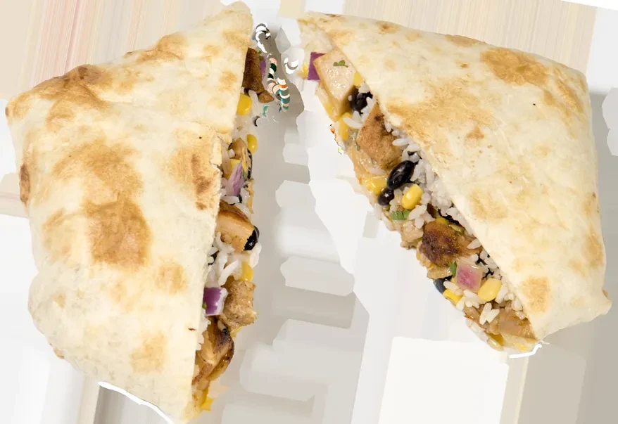 Diagonally cut burrito halves revealing rice, beans, corn, chicken filling.