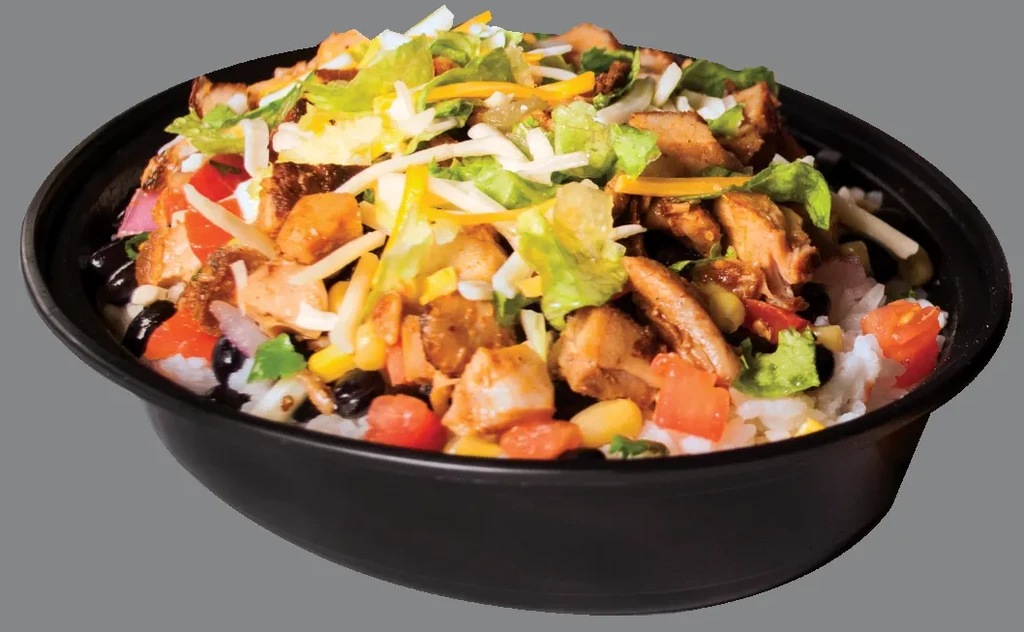 Vibrant chicken burrito bowl with rice, beans, and vegetables.