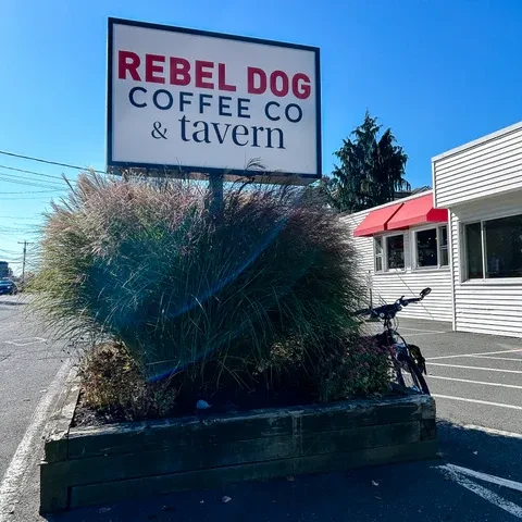 REBEL DOG COFFEE CO & TAVERN sign, planter, red awnings.