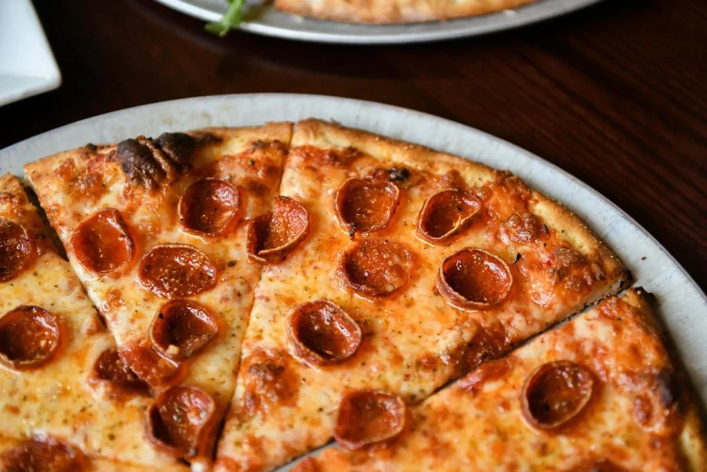 Freshly baked, sliced pepperoni pizza with melted cheese and crispy pepperoni.