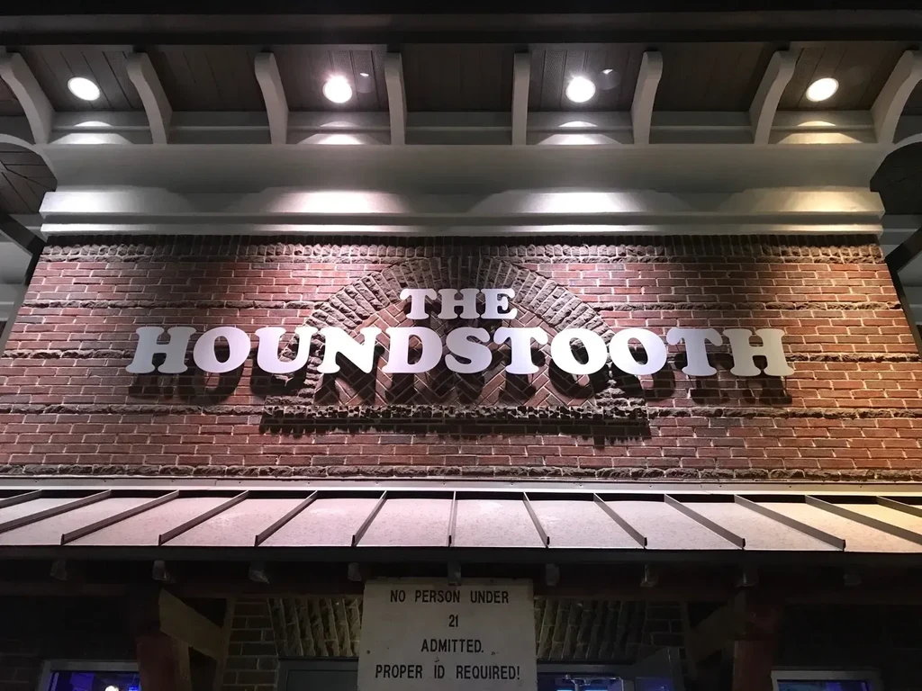 Night view of 'THE HOUNDSTOOTH' entrance, age restricted.