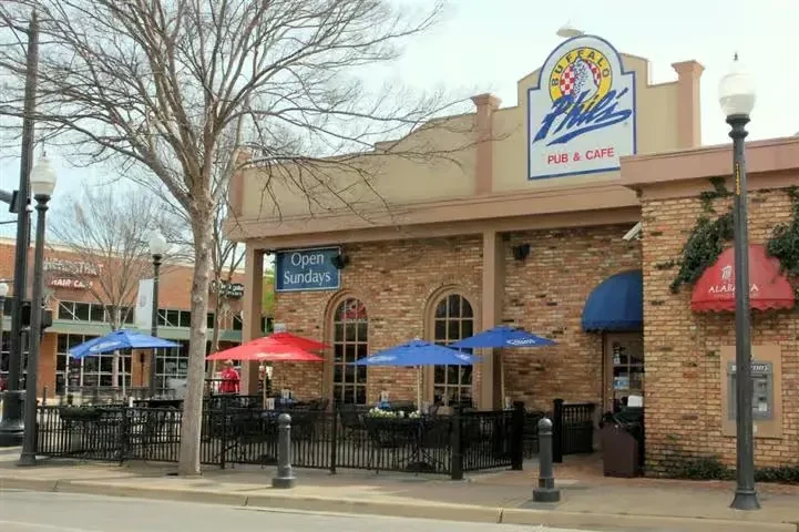 Buffalo Phil's Pub & Cafe: brick building with patio and bare tree.