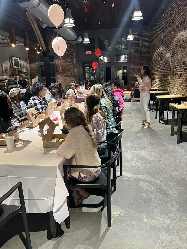 Woman leads workshop for group at industrial-chic venue.