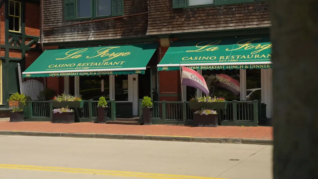 Historic La Forge Casino Restaurant exterior, green awnings, flower boxes.