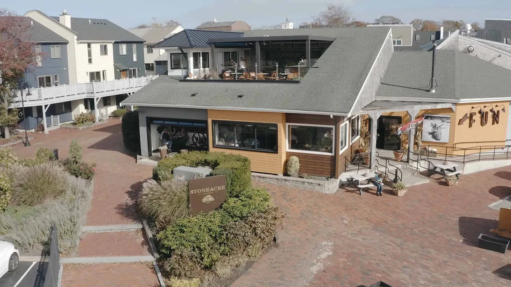 Aerial view of bustling Stoneacre Garden restaurant with rooftop and ground dining.