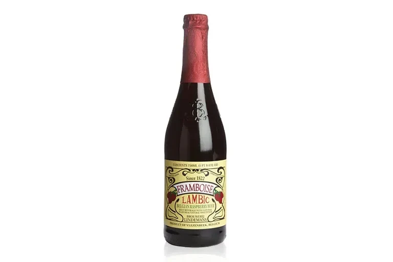 Lindemans Framboise Lambic raspberry beer bottle on reflective white surface.