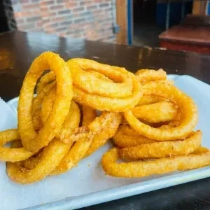 Generous serving of crispy golden-brown onion rings.