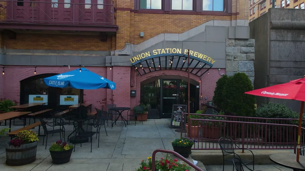 Union Station Brewery: brick exterior, outdoor patios, branded umbrellas.