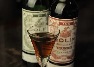 Dark amber cocktail in martini glass, Dolin Dry and Rouge vermouth.