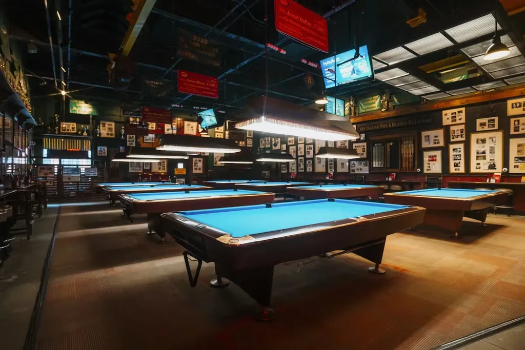 New England Pool & Billiard Hall of Fame with many blue tables.